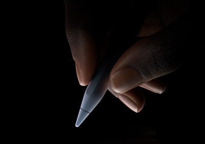 用戶用拇指和食指握住 Apple Pencil Pro 靠下三分之一左右的位置，做出書寫姿勢(shì)。