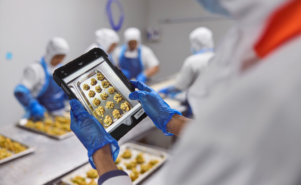 一名員工在 iPad 上進(jìn)行品控管理